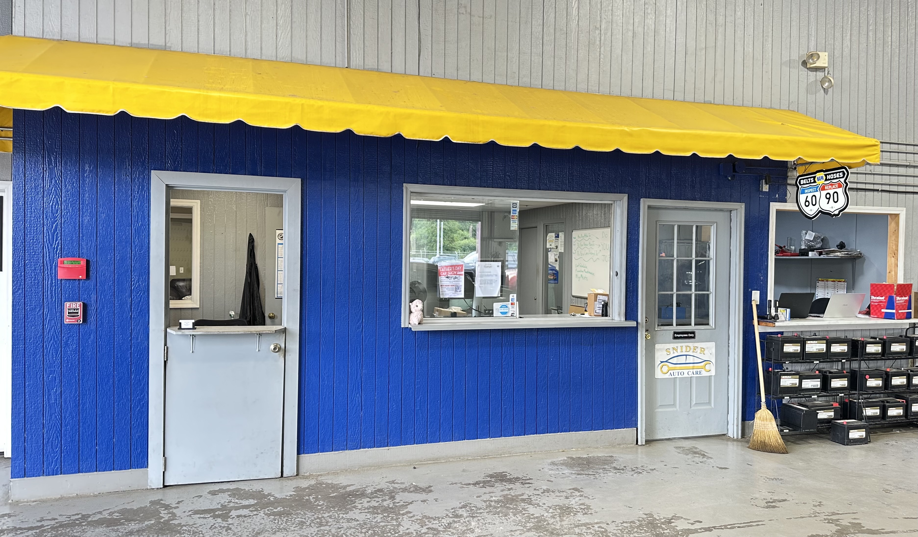 Snider Auto Care front service window with its blue-and-yellow awning
