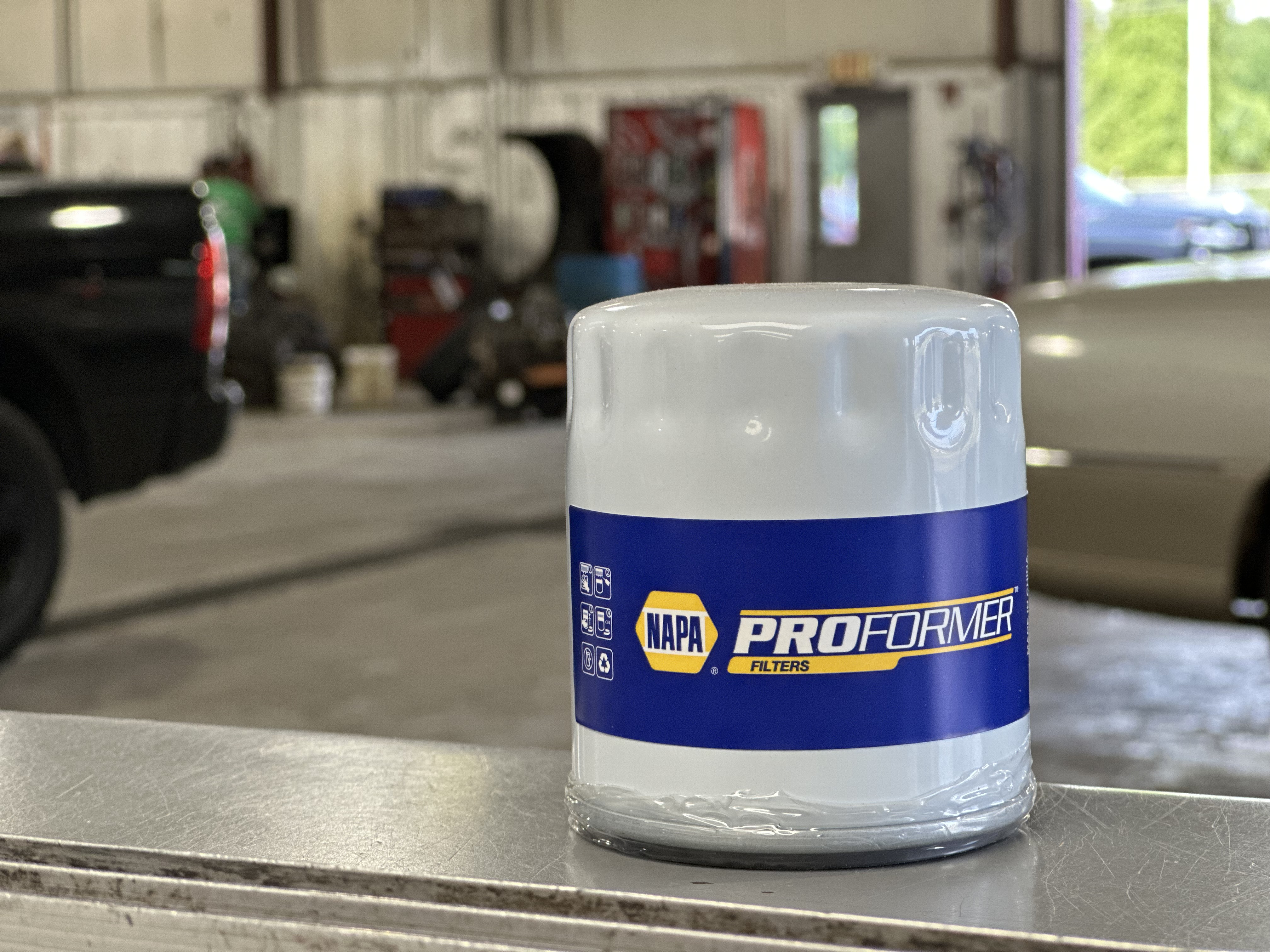 NAPA ProFormer oil filter on a service bay workbench at Snider Auto Care